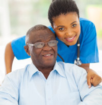 caregiver and elder man smiling